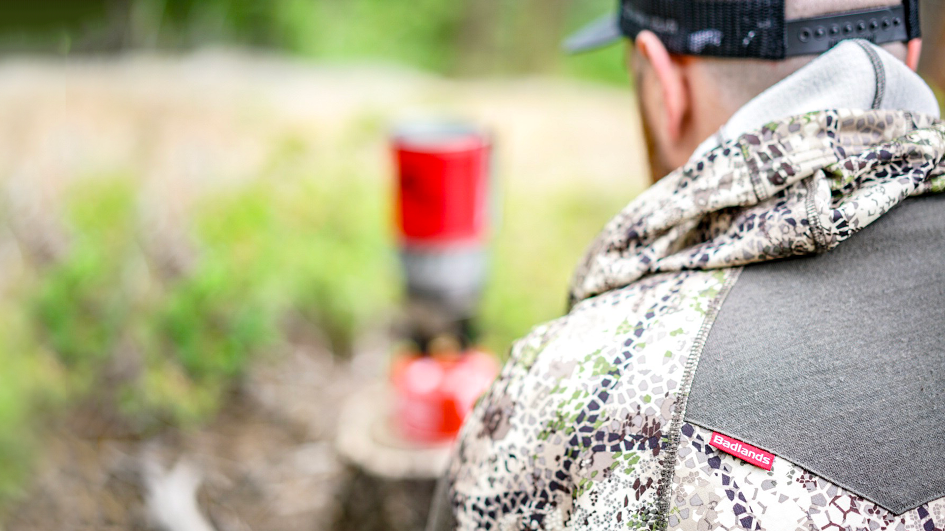 male hunter sitting at campsite
