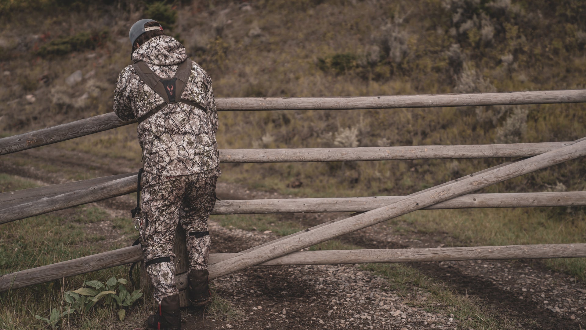 hunter leaning against railing