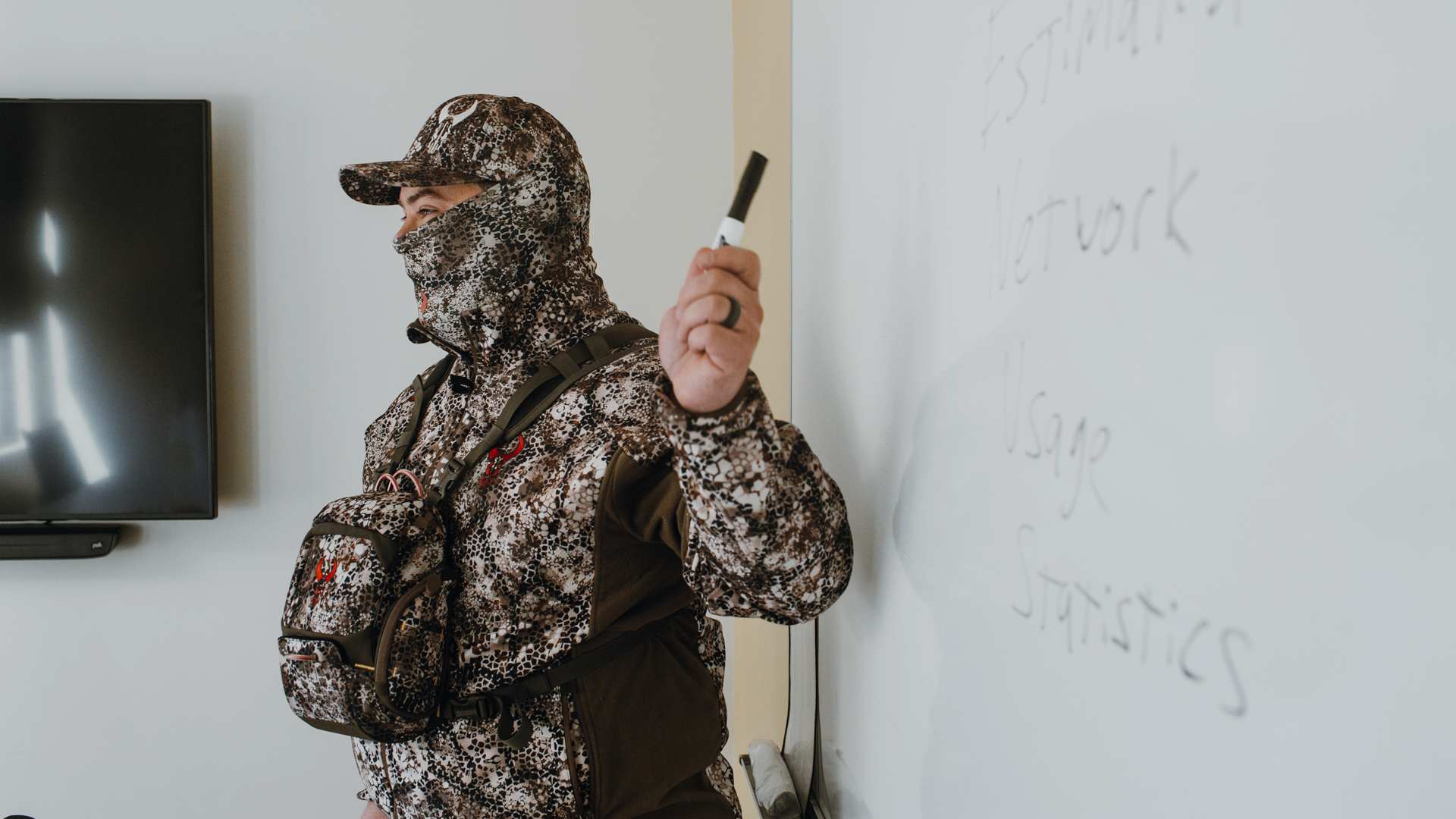 man in Moonrivers gear in front of whiteboard