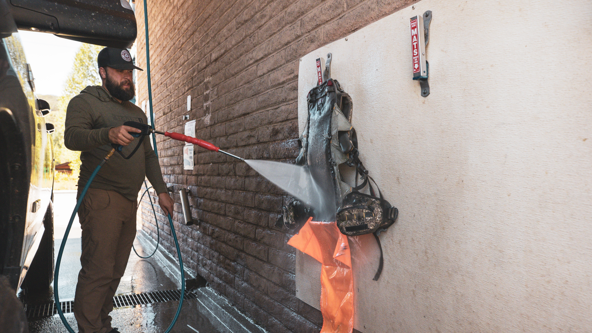 man cleaning hunting backpack