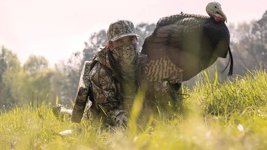 man on turkey hunting, holding turkey decoy