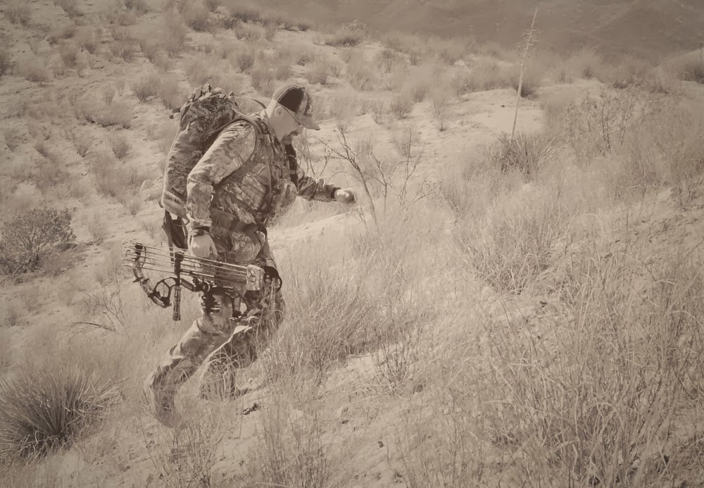 bow hunter walking up a hill
