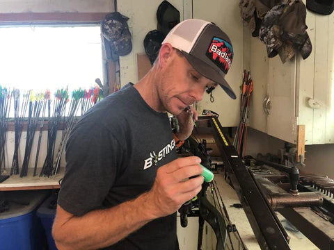 man prepping hunting equipment