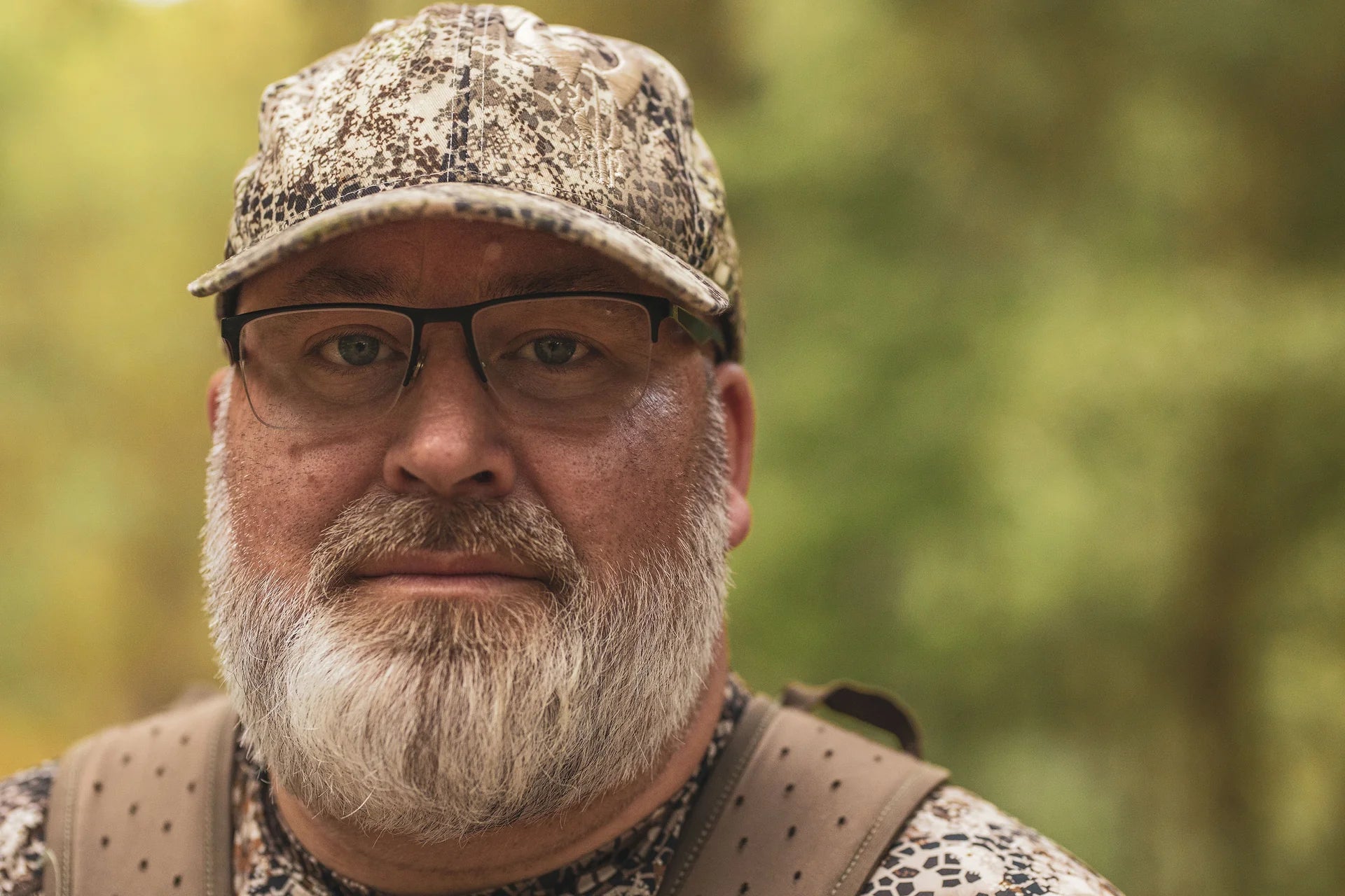 Person in Moonrivers camo gear outdoors; Moonrivers skull logo visible on shoulder strap.