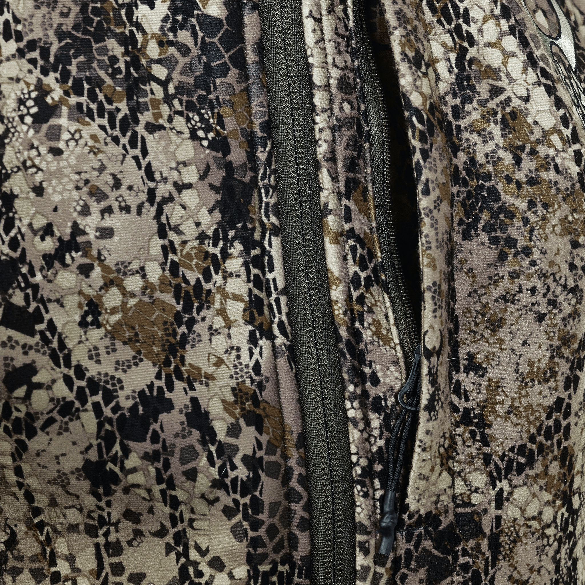 Close-up of a camouflage fabric with a zipper and the Moonrivers Logo visible in the upper right corner.