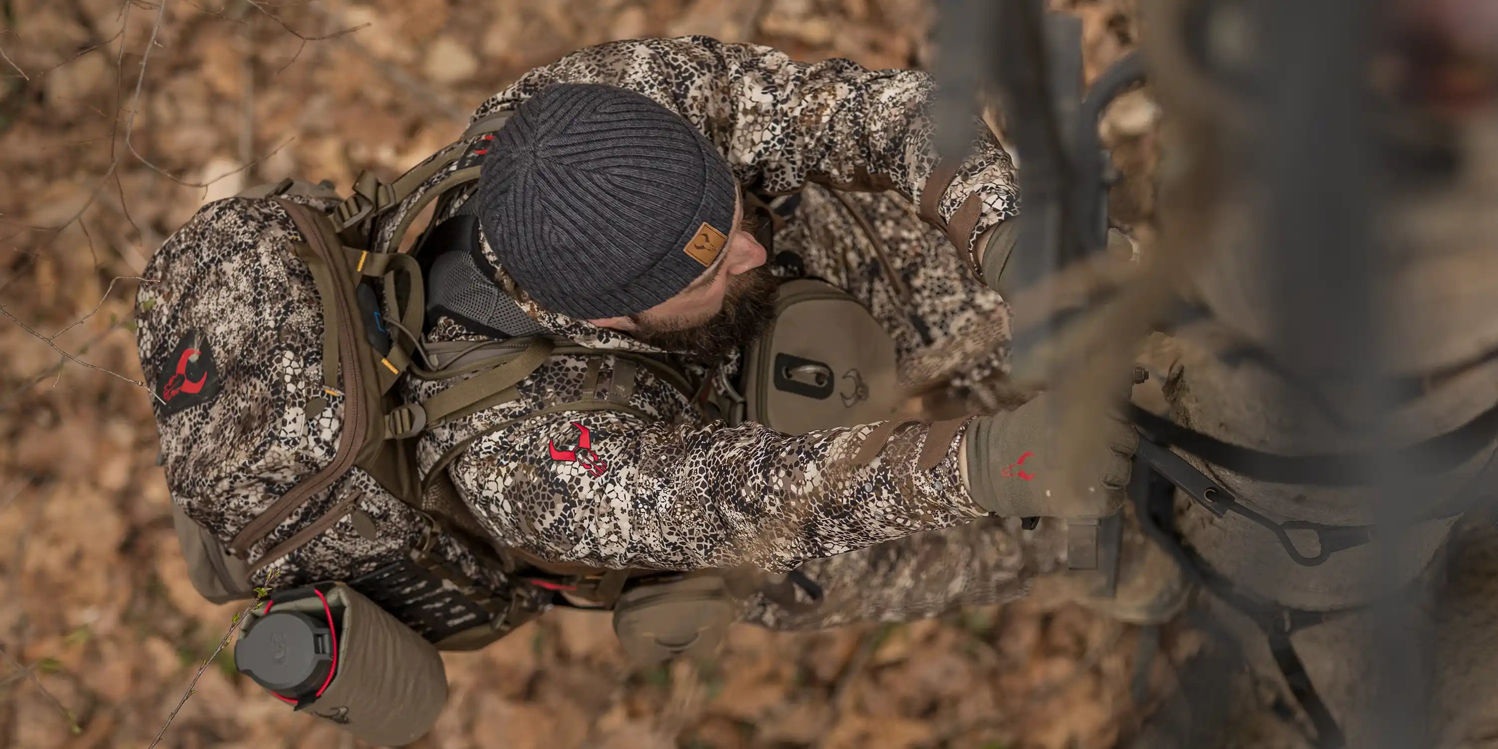 Hunter in Moonrivers camo climbs a tree stand; Moonrivers skull logo visible on gear and clothing.