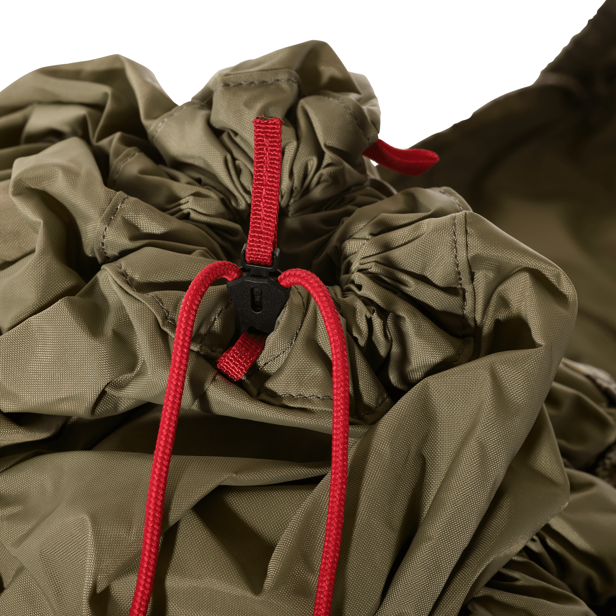 Close-up of Moonrivers pack drawstring closure with red cord and skull logo on olive fabric.
