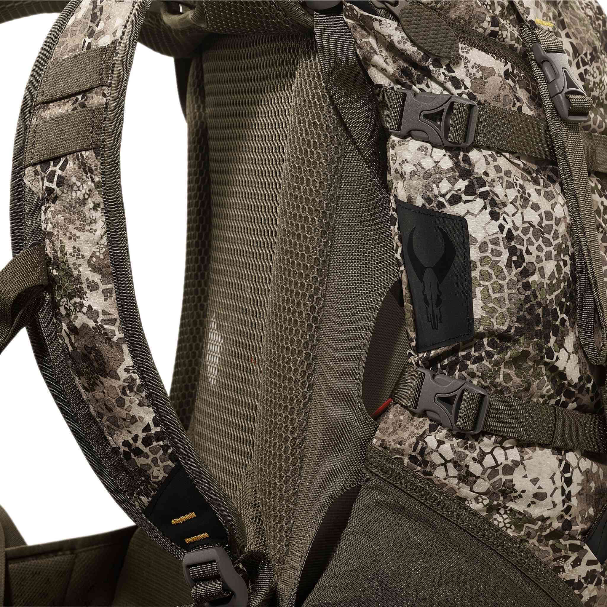 Close-up of a camo backpack with mesh padding and the Moonrivers skull logo patch on the side.