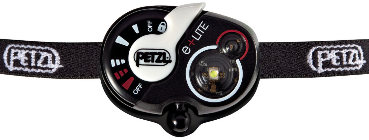 Close-up of a Petzl e+LITE headlamp with adjustable dial and logo on a black elastic headband.