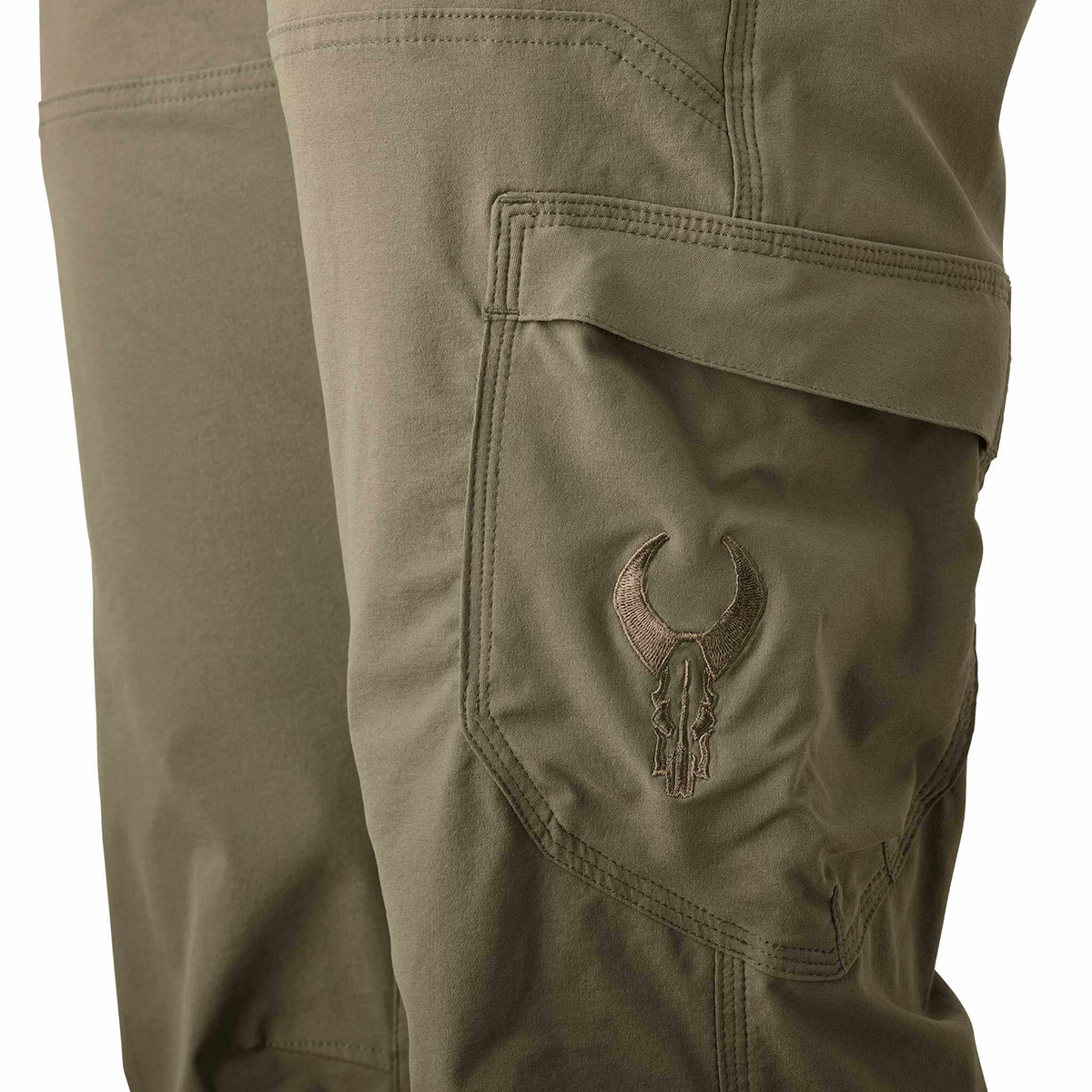 Close-up of olive cargo pants pocket featuring the Moonrivers skull logo embroidered on the flap.