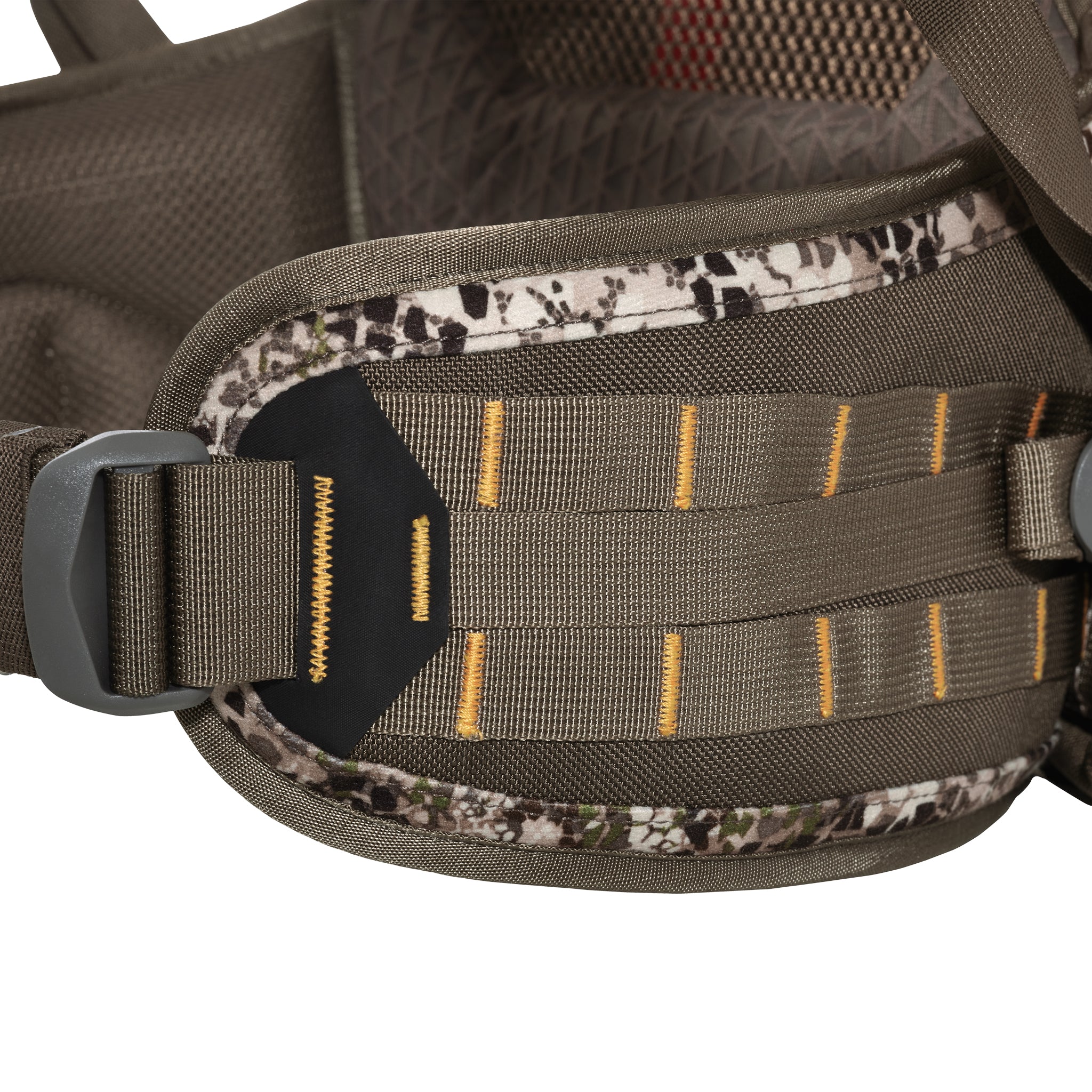 Close-up of a brown backpack hip belt with yellow stitching, camouflage trim, and adjustable buckle.