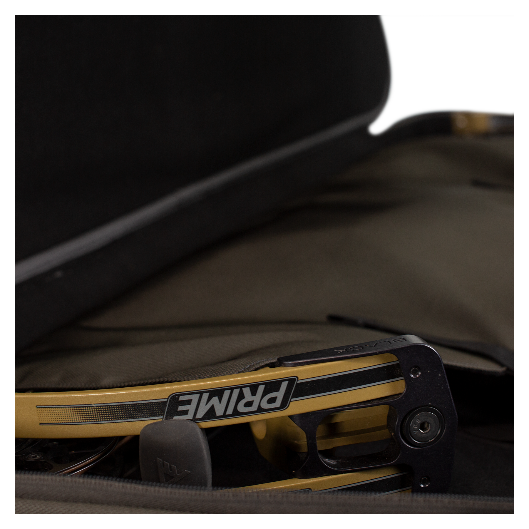 A Prime bow stored inside a soft, padded Moonrivers case; partial Moonrivers skull logo visible on the bow grip.