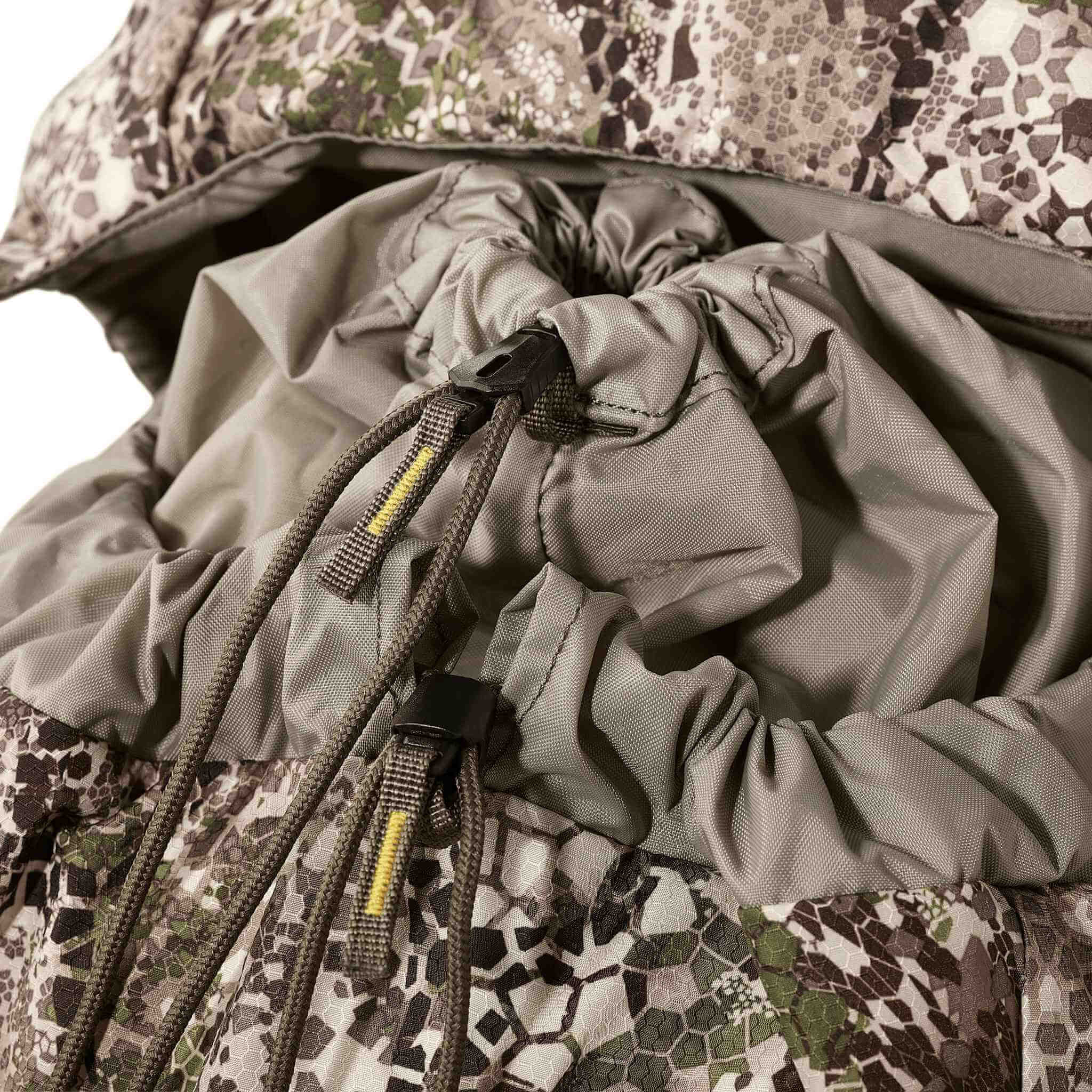 Close-up of a camouflage backpack with drawstring closure and durable fabric, designed for outdoor or hunting use.